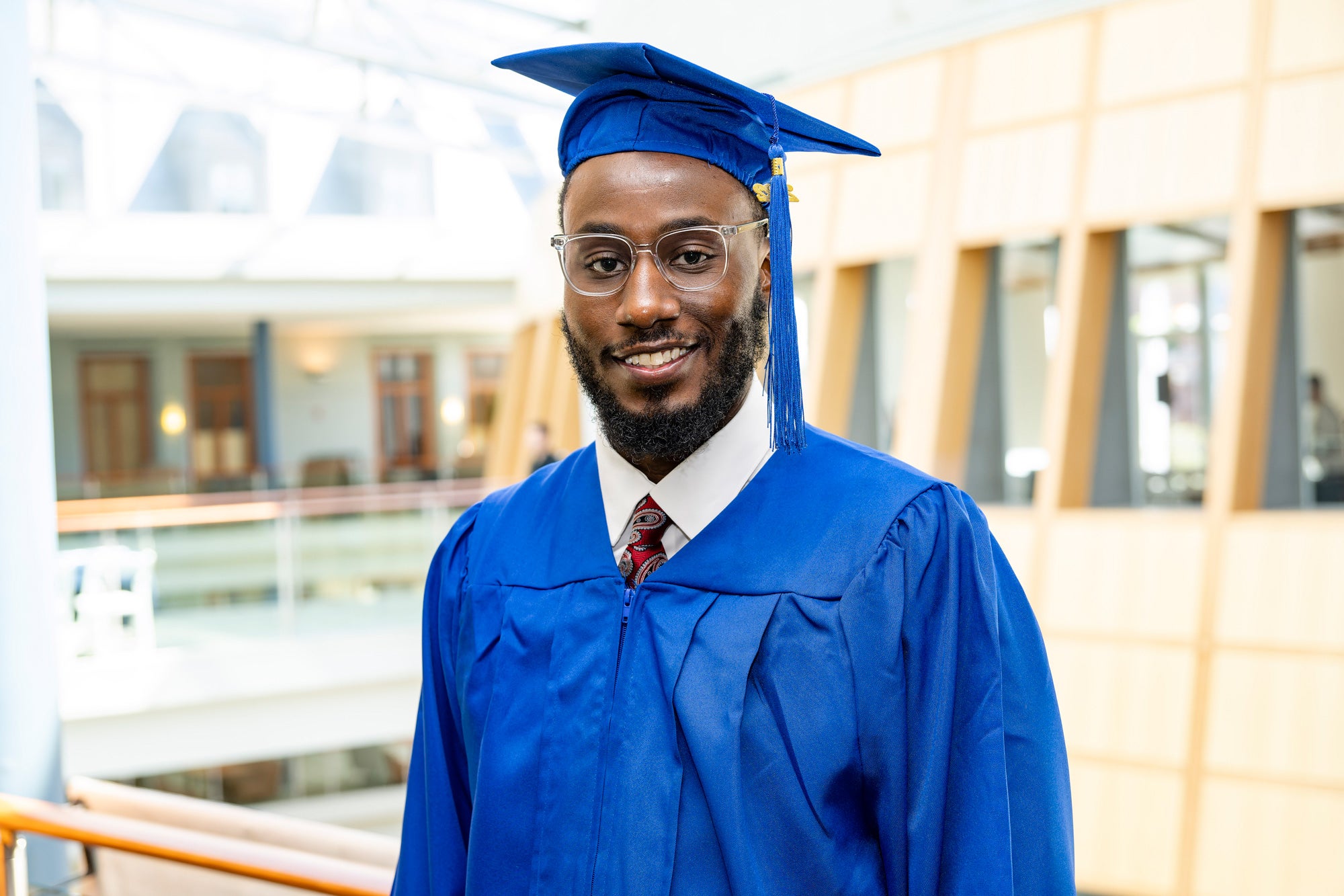 Mustafah Muhammad in graduation cap and gown
